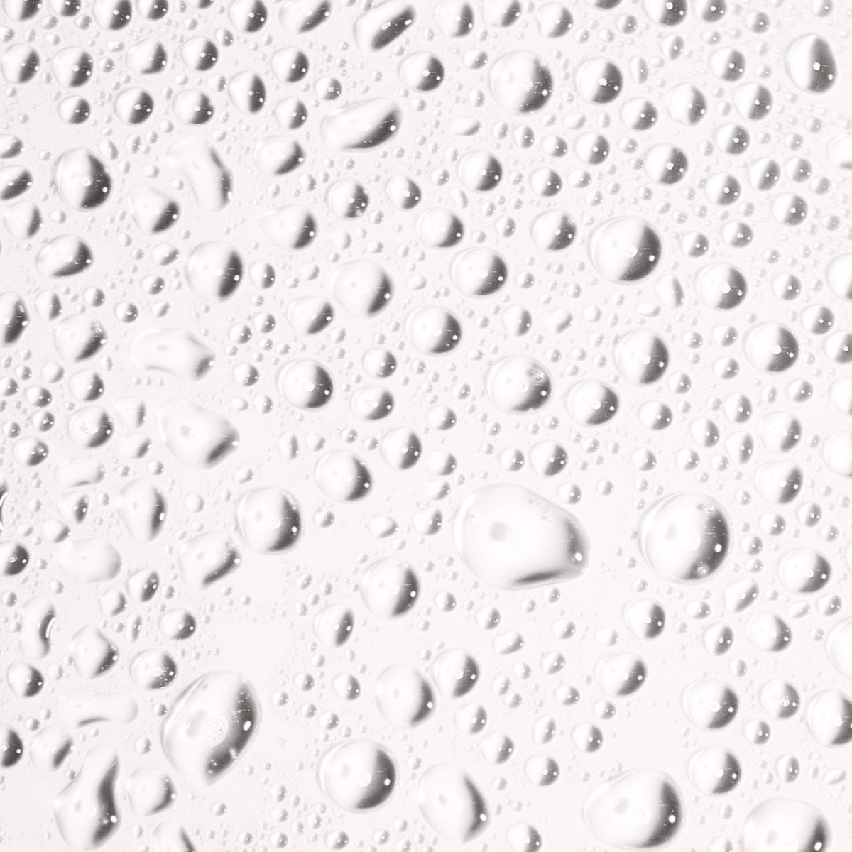 Close-up of water droplets on a surface, showcasing the refreshing texture of Face Tan Water.