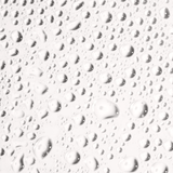 Close-up of water droplets on a surface, showcasing the refreshing texture of Face Tan Water.