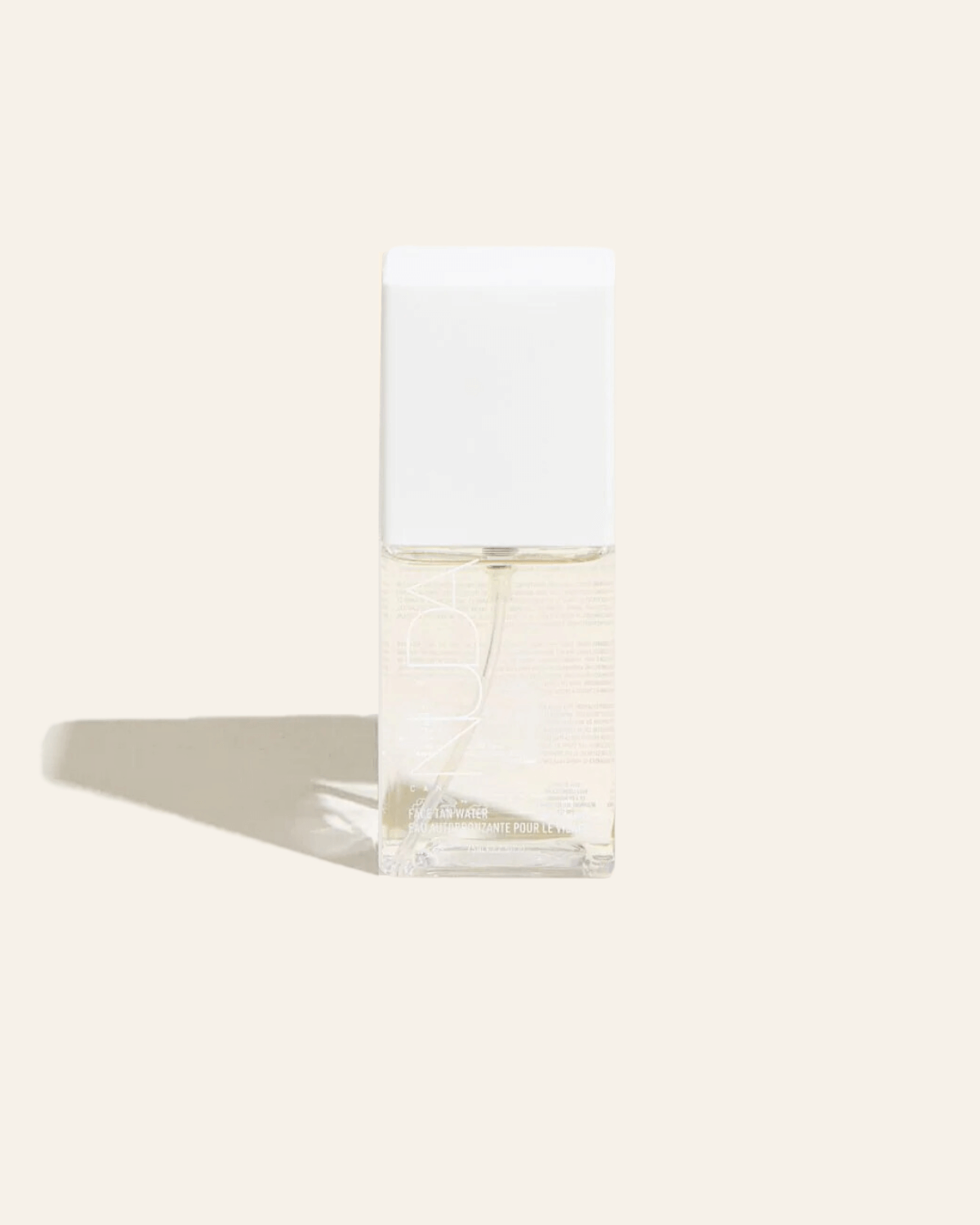 Bottle of Face Tan Water featuring lightweight, transparent formula with skin-enhancing ingredients for a natural, radiant glow.