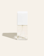 Bottle of Face Tan Water featuring lightweight, transparent formula with skin-enhancing ingredients for a natural, radiant glow.