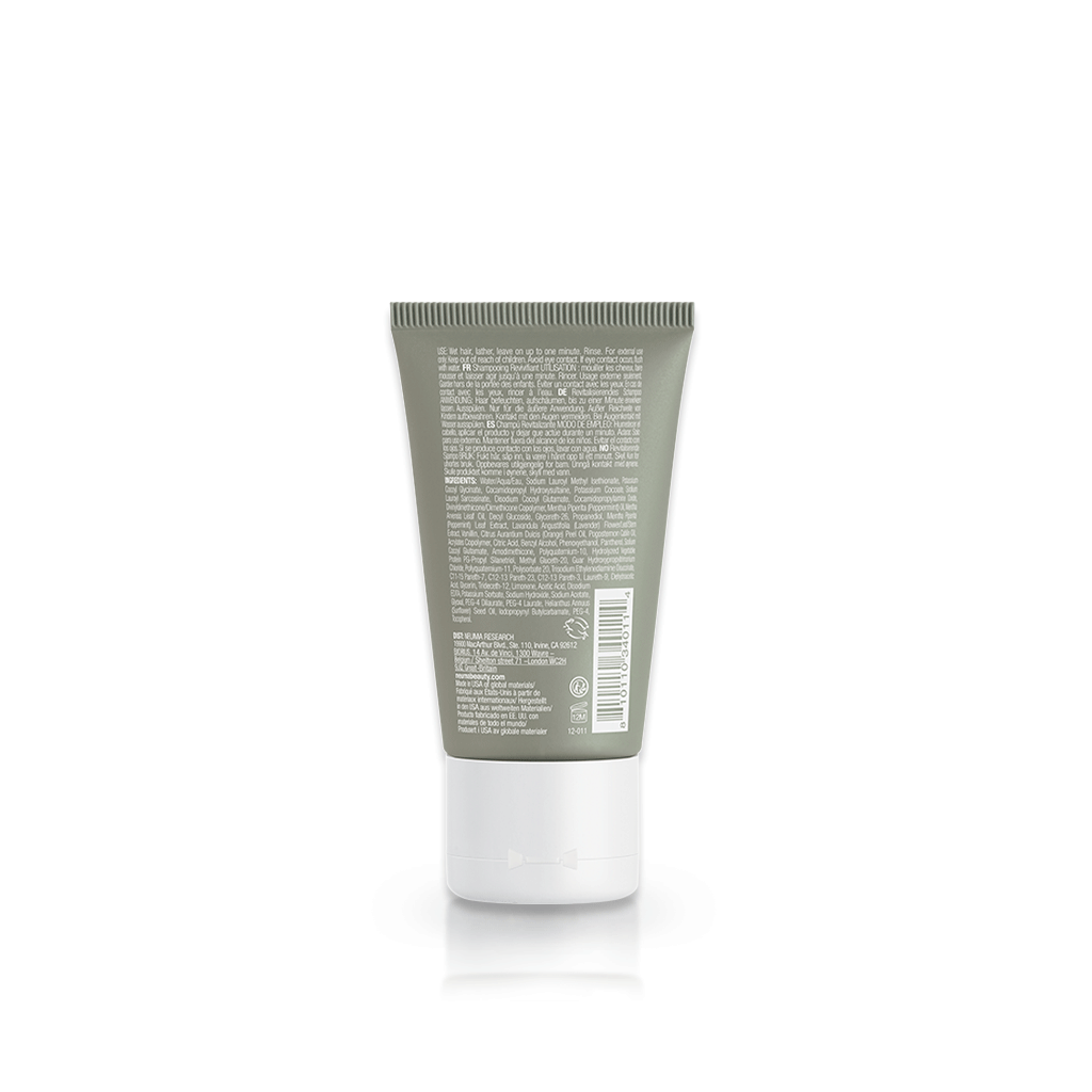 Back view of Re Neu Clarifying Shampoo bottle with product details and green packaging, sulfate-free and coconut-derived surfer.