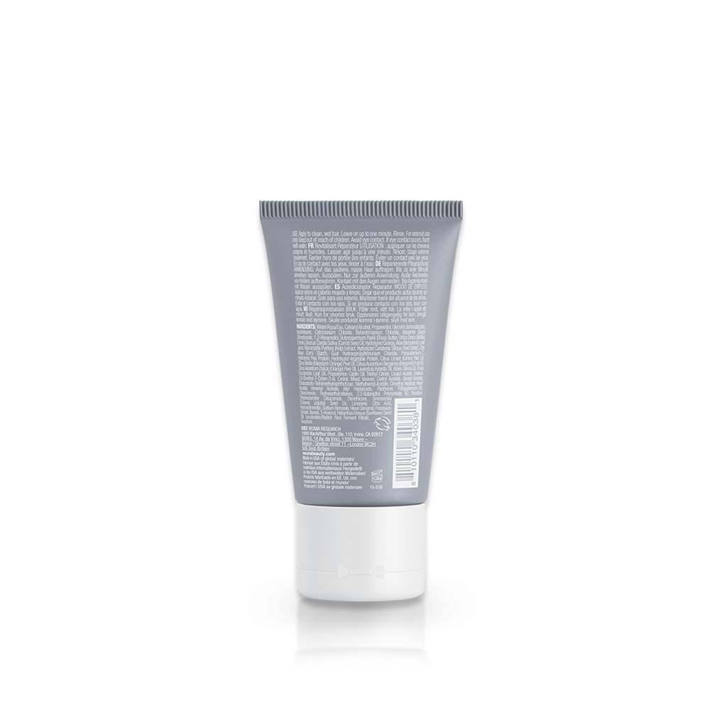 Back view of Neu Repair Conditioner tube, showcasing product details and description for ultra-reparative hair care.