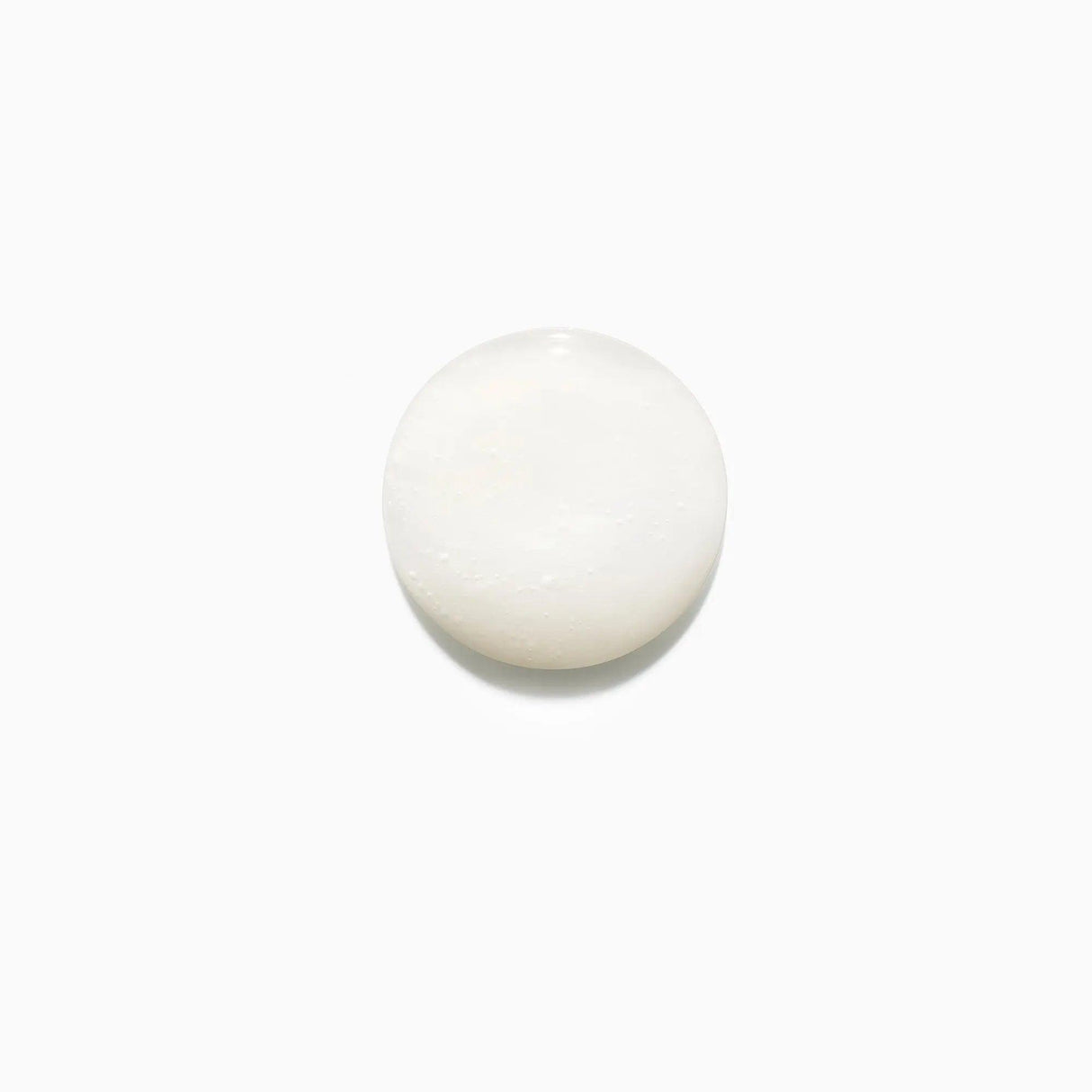 Texture of Kérastase Bain Fluidealiste Gentle sulfate-free shampoo for frizzy hair control on a white background.
