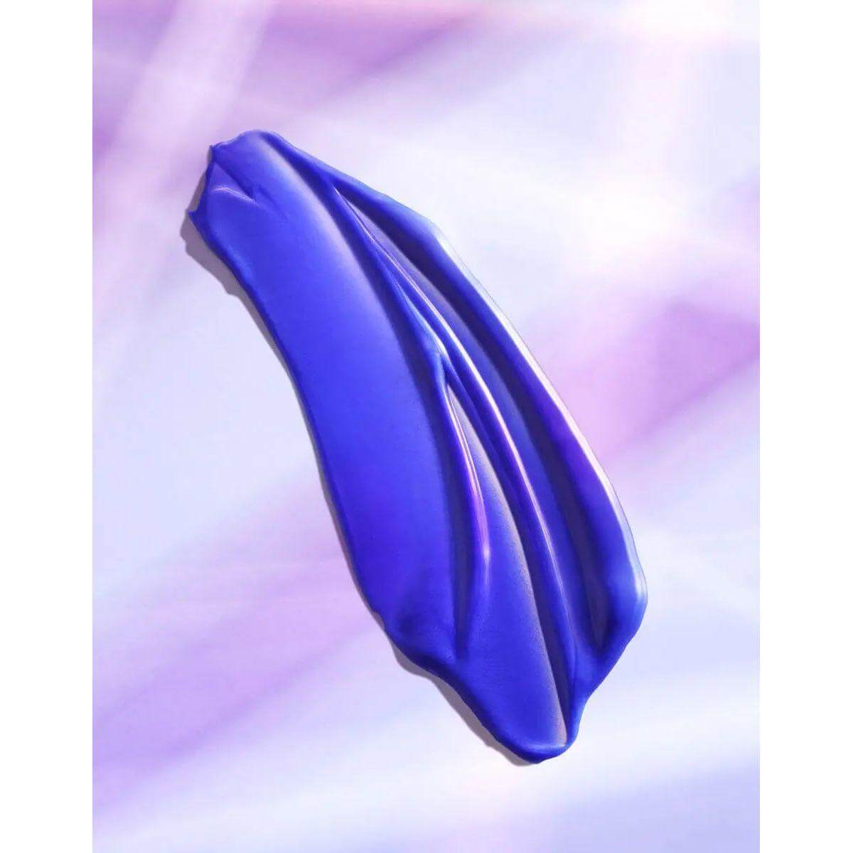 Vibrant blue swatch showcasing Moroccanoil Color Continue Shampoo's texture on a soft purple background.