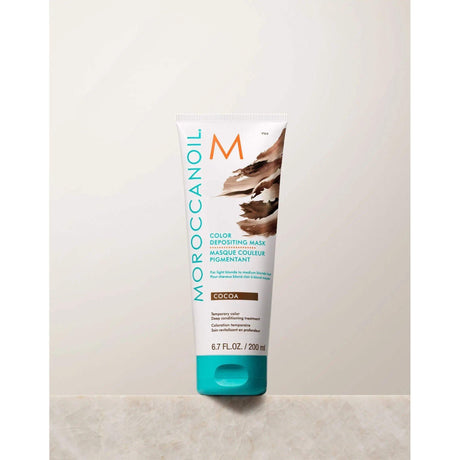 Moroccanoil Color Depositing Mask tube in cocoa shade for hair rejuvenation, tone enhancement, and radiant shine.