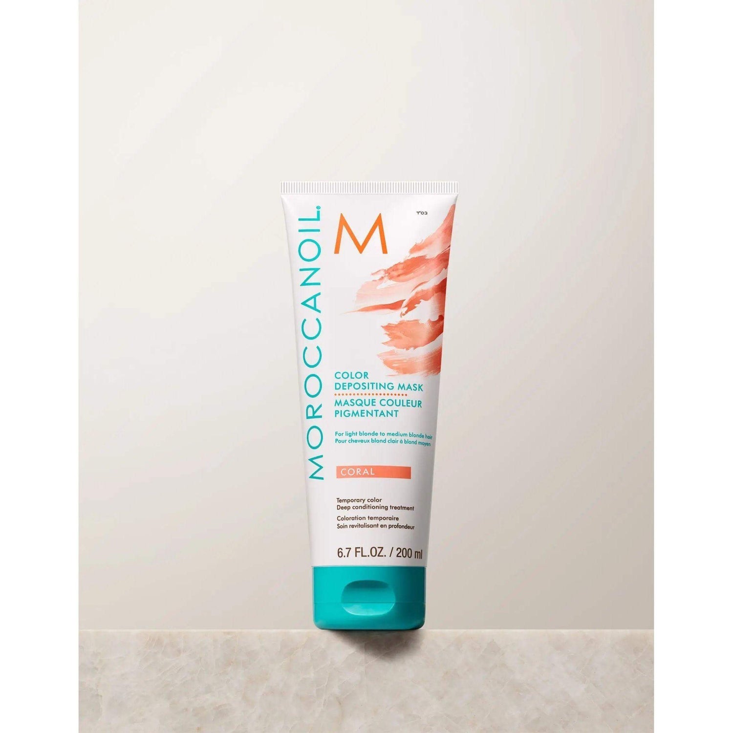 Moroccanoil Color Depositing Mask in Coral for enhancing hair tone, rejuvenating color, and deep conditioning.