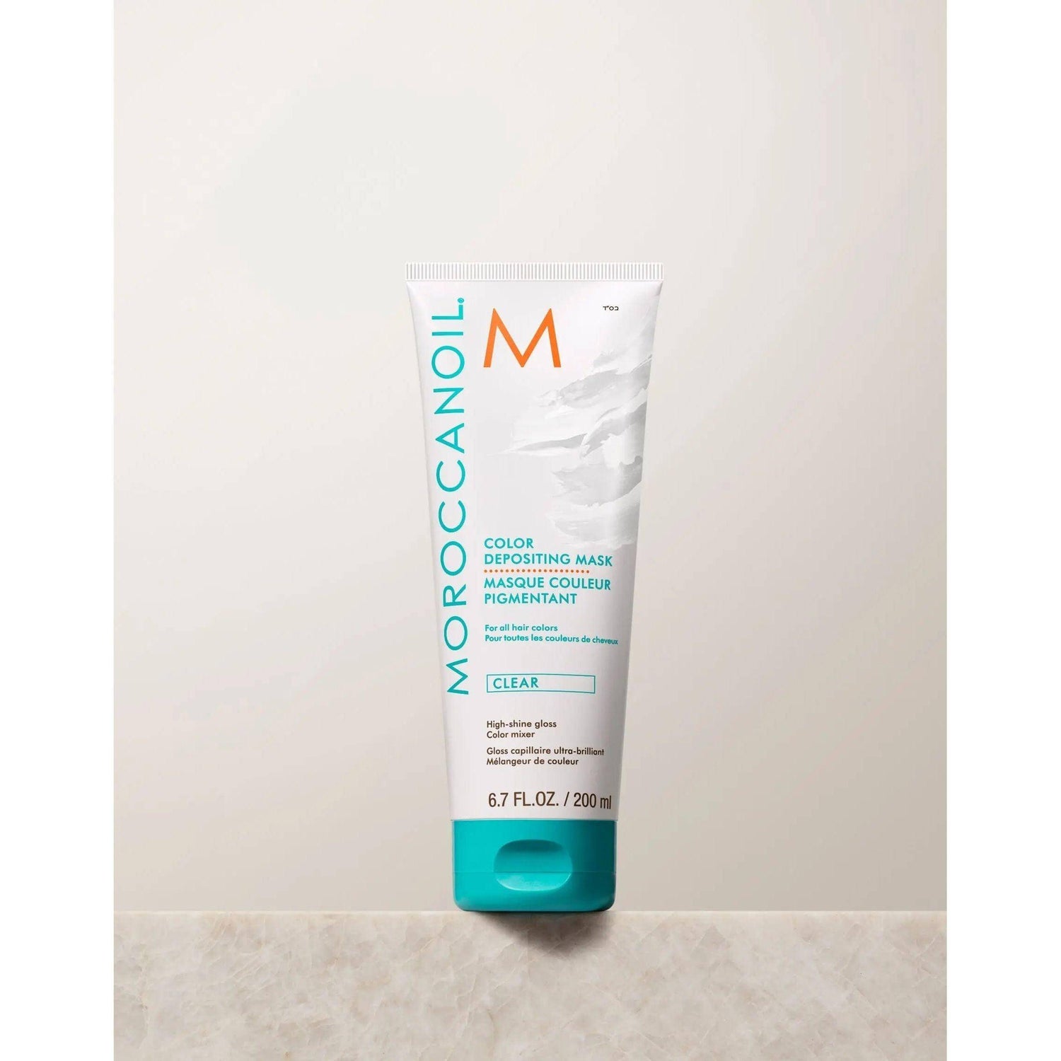Moroccanoil Color Depositing Mask tube for hair color refresh, deep conditioning, and shine, 6.7 fl oz, on a neutral background.