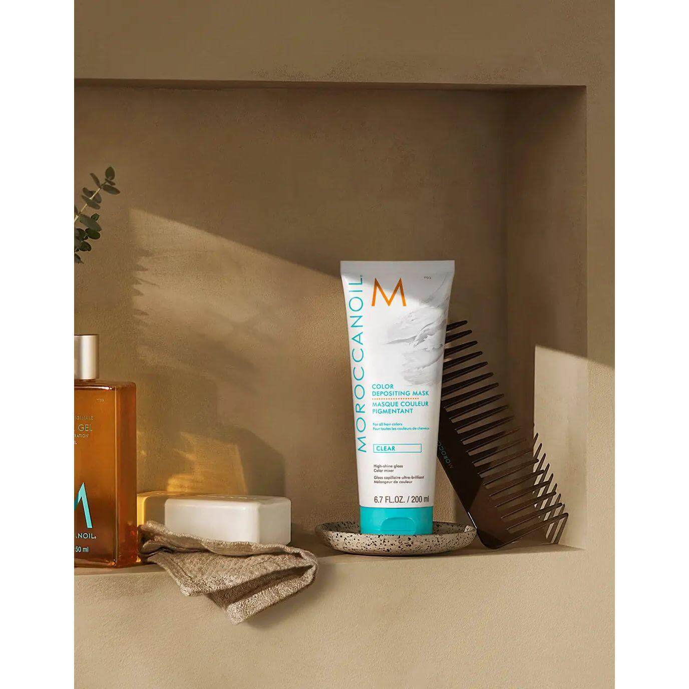 Moroccanoil Color Depositing Mask displayed with grooming essentials, enhancing hair tone, softness, and shine between salon visits.