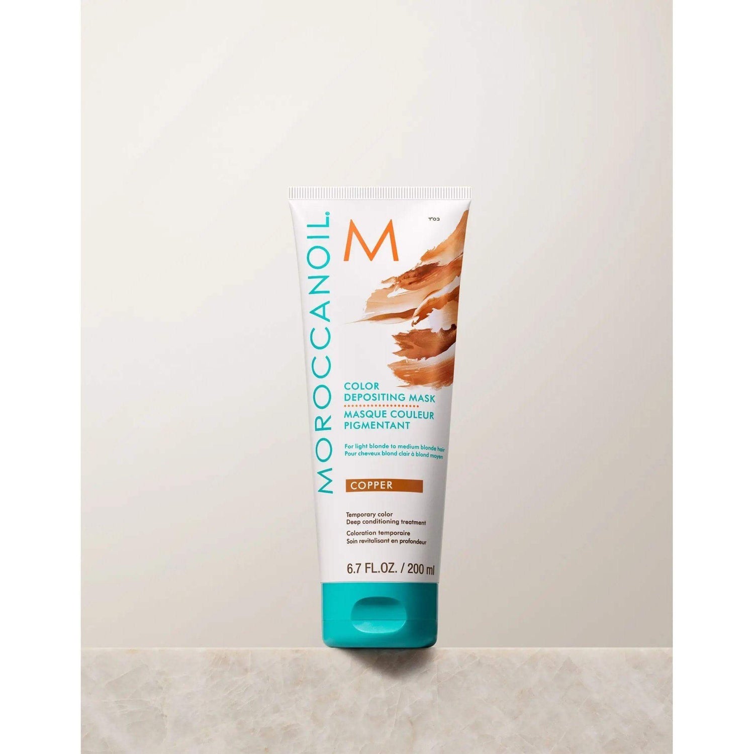 Moroccanoil Color Depositing Mask in Copper, 6.7 fl oz. Enhances tone, refreshes color, deep conditions, and adds radiant shine.