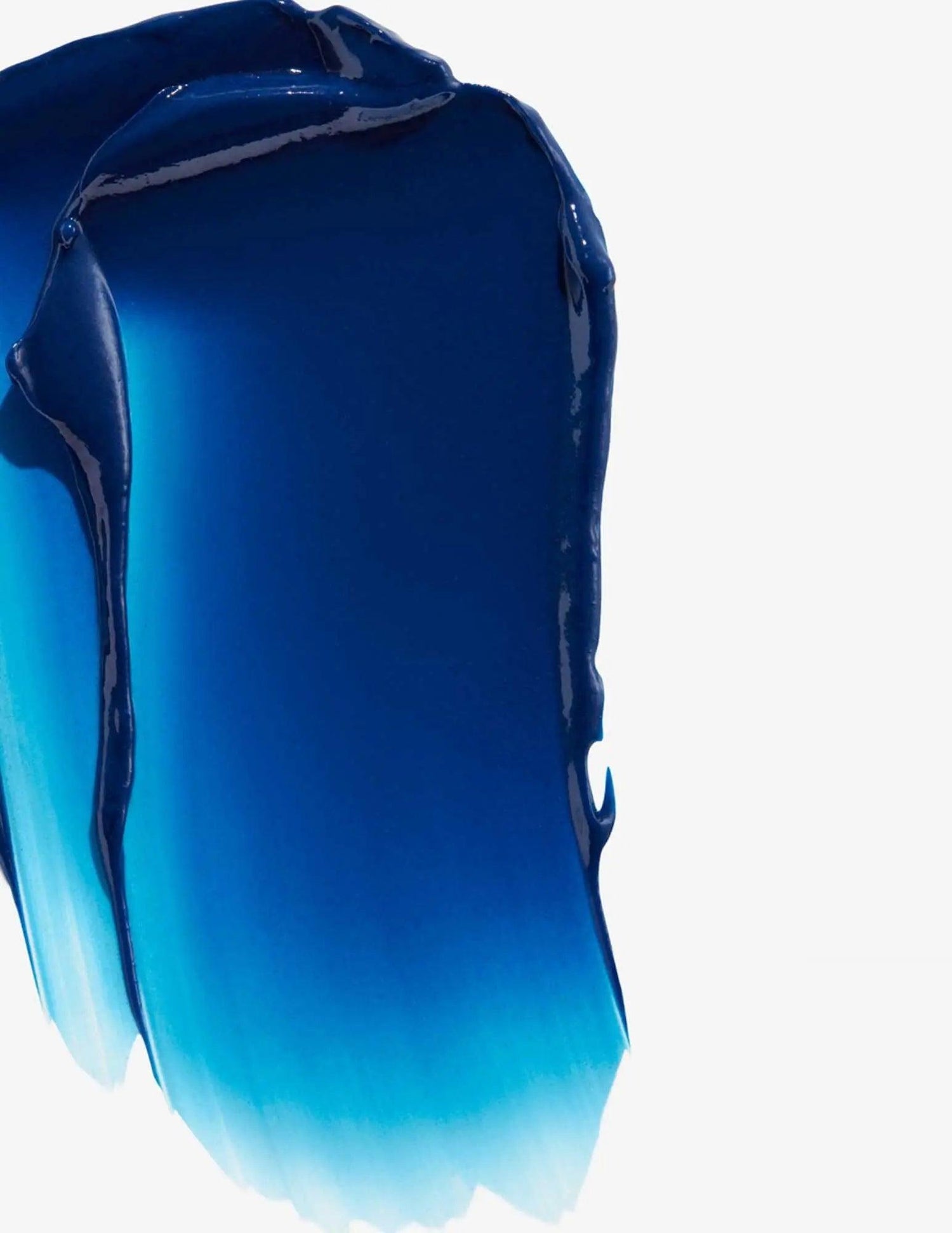 Swirled texture of Redken Color Extend Brownlights Conditioner with cool blue tones for neutralizing brassy hues in brown hair.