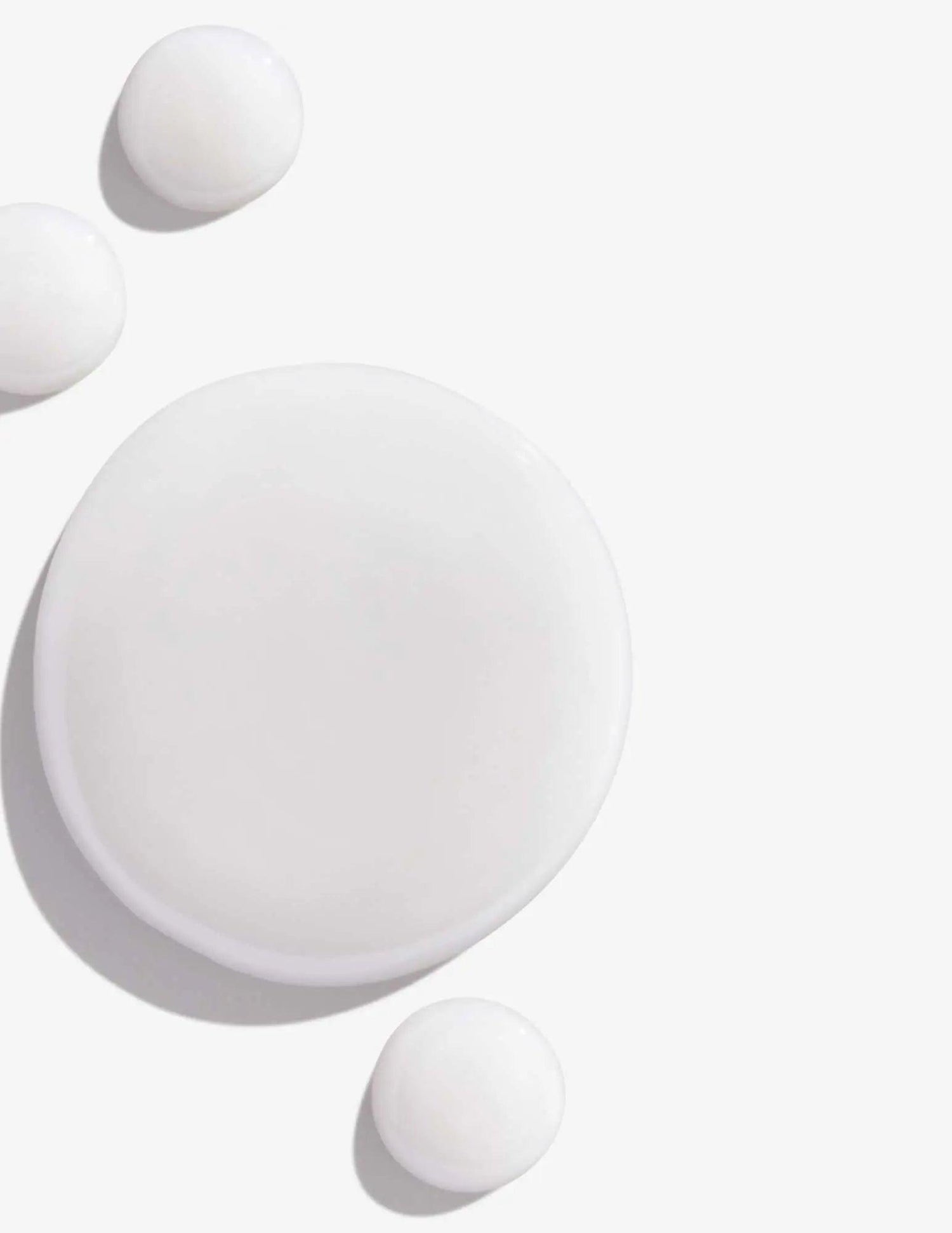 Swirls of Redken Color Extend Shampoo for color-treated hair, highlighting texture and creamy consistency.