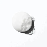 Texture sample of Curl Manifesto Bain Hydration Douceur sulfate-free shampoo with light bubbles, ideal for curly and coily hair.