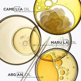 Camelia, Marula, and Argan oils in glass dishes, highlighting ingredients for Elixir Ultime Hair Oil.