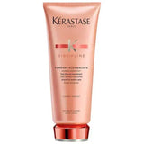 Kerastase Fondant Fluidéaliste Conditioner for frizzy hair in a pink tube, controls frizz and enhances manageability.