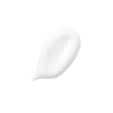 Texture of Kerastase Fondant Fluidéaliste Smoothing Conditioner for frizzy hair on white background.
