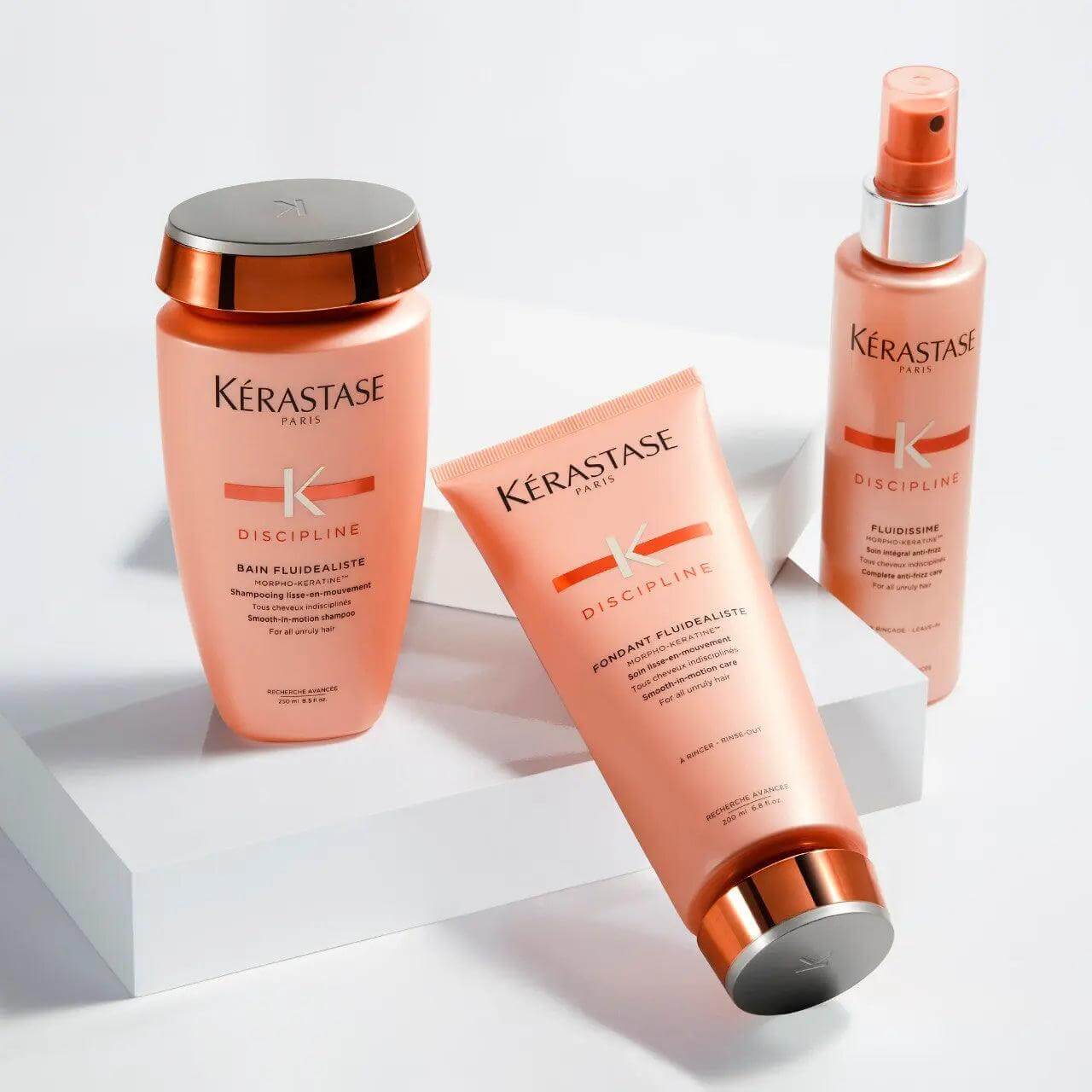 Kerastase Discipline hair care set with Fondant Fluidéaliste conditioner for frizzy hair, enhancing manageability and smoothing.
