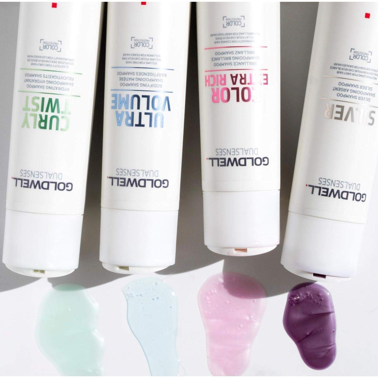 Goldwell Dualsenses shampoo range, including Curly Twist, Ultra Volume, Color Extra Rich, and Silver, with samples on white background.