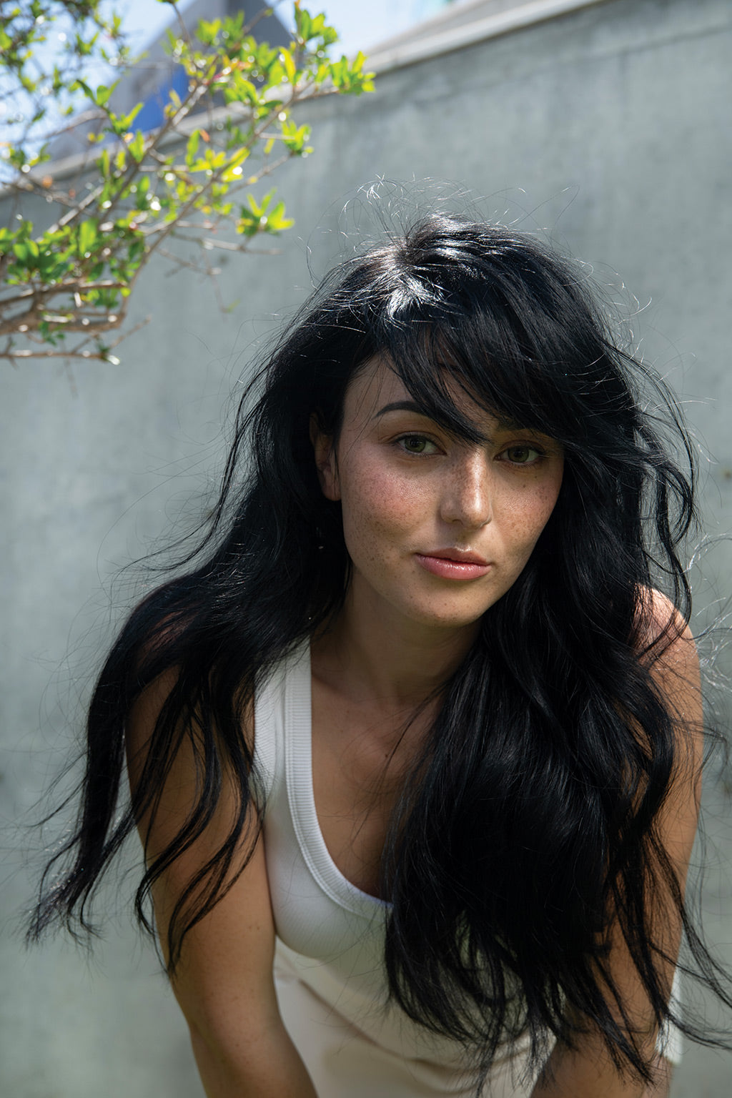 Woman with long, wavy black hair styled effortlessly using Neu Styling Air-dry Shaper for natural texture and shine.