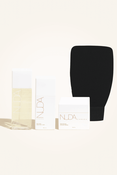 Body Essentials Kit with exfoliant, tan remover, exfoliating mitt, and hydrating body cream for sunless tanning preparation.