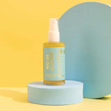 Rio De Janeiro Dry Shimmering Oil bottle on display, 2 oz size, yellow gold color, featuring organic coconut oil for a radiant glow.