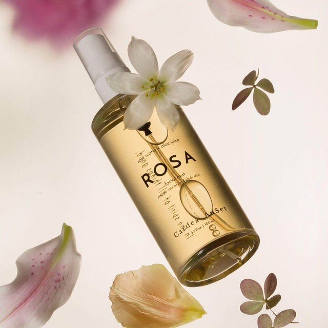 Rosa Facial Mist bottle with natural floral elements, featuring hydrating rose water and aloe juice for refreshed, glowing skin.