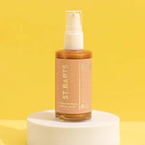 St.Barts Dry Shimmering Oil in bronze, 2 oz bottle, featuring kiwi, pineapple, and coconut scent for a radiant glow on all skin tones.