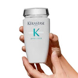 Kerastase Symbiose Bain Crème Apaisant shampoo bottle for soothing sensitive scalp, held in hands, suitable for all hair types.